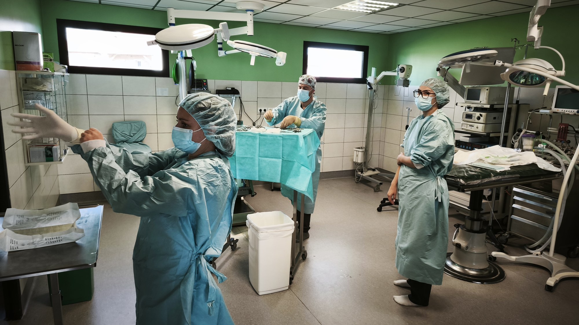 Bloc chirurgical : habillage stérile, préparation de la table d'instruments et équipe en tenue